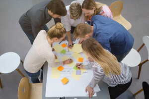 Teilnehmer/innen machen sich auf einem Workshop Notizen. 